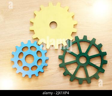 Collaboration, engineering and construction concept with industrial gears, mechanics and cogs on a table or desk in an office. Teamwork, synergy and Stock Photo