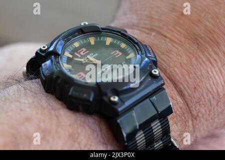 Well-worn Casio wristwatch with chipped and faded markings and replacement band and other hardware. Stock Photo