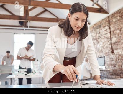 Architect, blueprint and design with a woman engineer working on a plan in her office at work. Construction, designer and architecture with a female Stock Photo