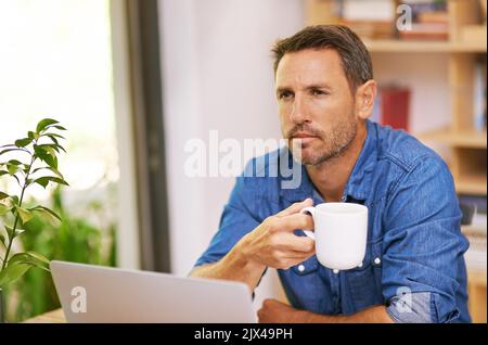 Fueling up on some caffeine before starting the workday. A young woman drinking coffee while working from home. Stock Photo