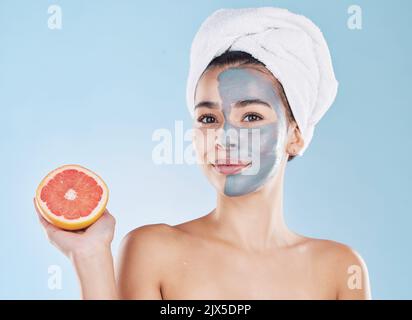 Woman, skincare and grapefruit face mask, organic beauty and wellness for healthy antiaging, fresh detox and natural clean facial on blue background Stock Photo