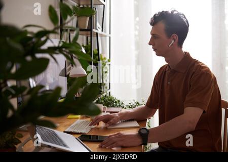 Software developer talking to team leader at online meeting when working from home Stock Photo