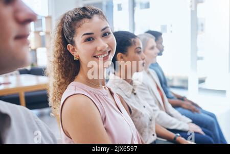 Training, team and woman in a happy business meeting with a smile sitting in a conference or workshop convention for coaching. Portrait of a female Stock Photo