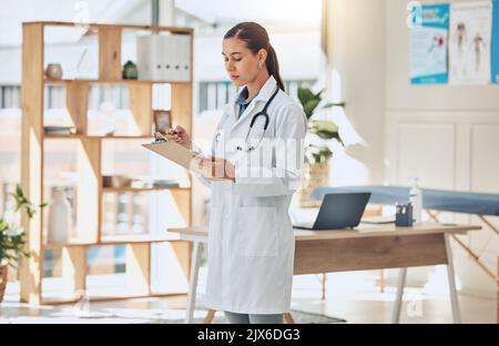 Doctor writing analysis, reading test results and consulting document information in wellness clinic. Hospital woman, notes and medicine research for Stock Photo