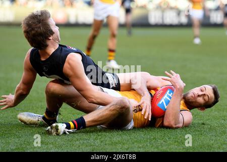 Brodie Smith of the Crows wins the ball against Liam Sumner of the