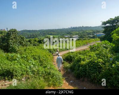 Mumbai, Maharashtra / India – March 2, 2020 : Countryside village small curvy road. Greenery, trees visible in path. Stock Photo