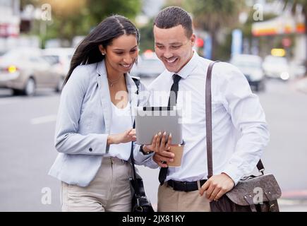 5g tablet internet and social media live streaming watching of a couple after work in a city. Happy work friends or partners with a smile looking at a Stock Photo