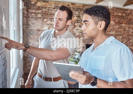Teamwork, strategy and architects working on a tablet and planning a floor, building or house plan. Architecture, design and workers or engineers Stock Photo