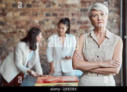 Elderly woman, art gallery manager and exhibition room working talking. Interior design business, review paintings and project teamwork. Serious buyer Stock Photo