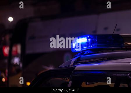 Emergency light of police patrolling car on street in night Stock Photo