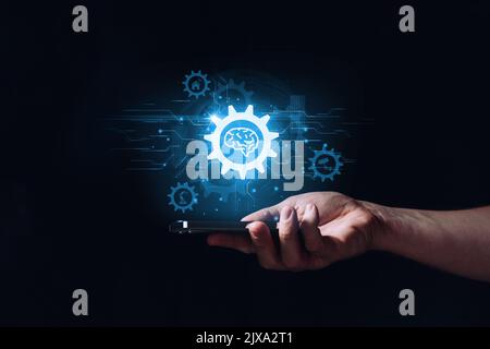 Concept artificial intelligence or ai. Hologram with brain icon over hand Stock Photo