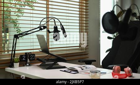 Home studio with professional condenser microphone, laptop and headphone. Entertainment, podcasts and technology concept Stock Photo