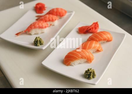 Traditional Japanese cuisine. Fresh made Sushi with salmon and shrimps Stock Photo