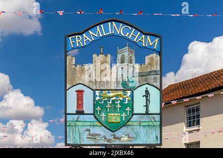 Town sign, Framlingham, Suffolk, England, UK blue sky with bunting flags Stock Photo