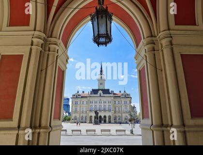 City Hall viewed from below the arches of the Name of Mary Church, Liberty Square, Novi Sad, Serbia Stock Photo