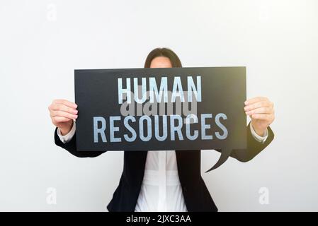 Hand writing sign Human ResourcesThe people who make up the workforce of an organization. Word Written on The showing who make up the workforce of an Stock Photo