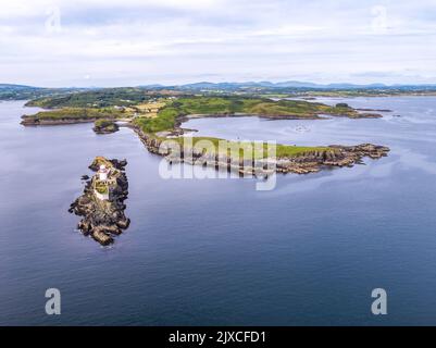 Aerial of the Rotten Island Lighthouse with Killybegs in background - County Donegal - Ireland. Stock Photo