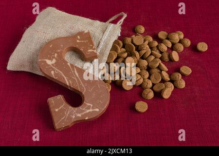 Dutch Sinterklaas tradition: A chocolate letter and a bag with candy called Pepernoten. Stock Photo