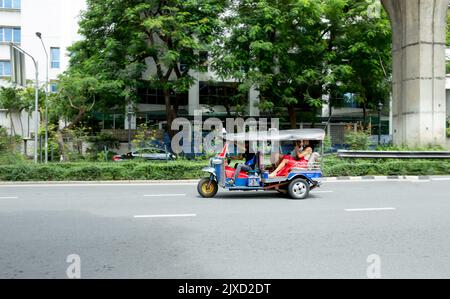 Lumphini, THAILAND - August 26, 2022 : Tricycle (tuk-tuk) running fast on the road area lumphini in Bangkok, Thailand. Stock Photo