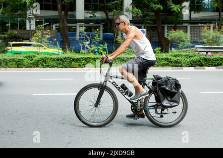 Lumphini, THAILAND - August 26, 2022 : People is biking fast on the road area lumphini in Bangkok, Thailand. Stock Photo