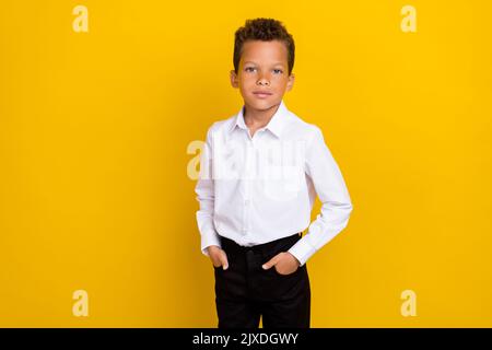 Photo of handsome boy hand pocket dressed nice stylish clothes outfit stand empty space isolated on yellow color background Stock Photo