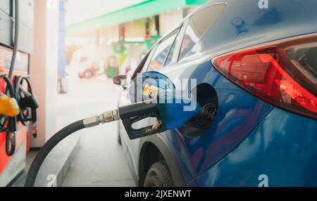 Car fueling at gas station. Refuel fill up with petrol gasoline. Petrol pump filling fuel nozzle in fuel tank of car at gas station. Petrol industry Stock Photo