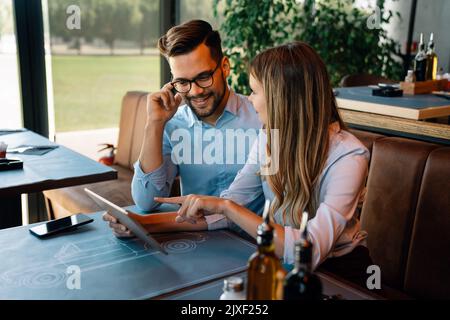Group of happy multiethnic successful business people having fun, work and meeting in cafe. Stock Photo