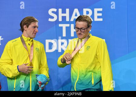 Gold medalist Jack McLoughlin of Australia (left) and bronze medalist Mack Horton (right) are seen during the medal ceremony for the Mens 1500m Freestyle Final on day six of swimming competition at the XXI Commonwealth Games at Gold Coast Aquatic Centre on the Gold Coast, Australia, Tuesday, April 10, 2018. (AAP Image/Darren England)