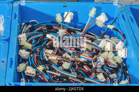 Blue container with bunch of colored cables, connections, wires. Industrial background. Stock Photo