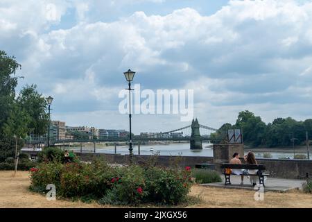 London- August 2022: Hammersmith Thames path with Hammersmith Bridge over the River Thames Stock Photo