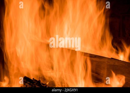 In a traditional firewood oven for wood fired pizza, a flame is blazing from the fire which is burning brightly Stock Photo