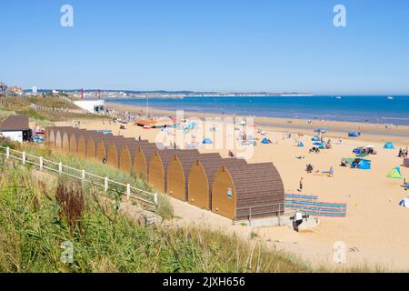 Bridlington Beach Yorkshire South beach huts tourists holidaymakers and people sunbathing on the beach at Bridlington Yorkshire England UK GB Europe Stock Photo