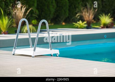 Residential Outdoor Swimming Pool Ladder Close Up. Backyard Recreation Theme. Stock Photo