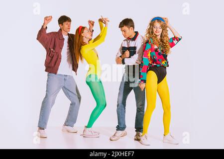 A group of disco girls in African American wigs and colorful costumes on a  white background. Fashion of the seventies and eighties Stock Photo - Alamy