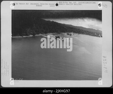 A Douglas A-20 of the 5th Air Force's 3rd Bombardment Group, 90th Bombardment Squadron flies mast-high over Japaneseanese ships at Manokwari, Dutch New Guinea during an attack on June 9, 1944. Stock Photo