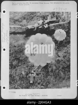 THE DEVASTATING HOLLANDIA ATTACK. These continued attacks ran the total score up to 288 enemy planes destroyed. This daring close-up shows a parachute bomb after dropping from a U.S. Army 8th Air Force plane. Stock Photo