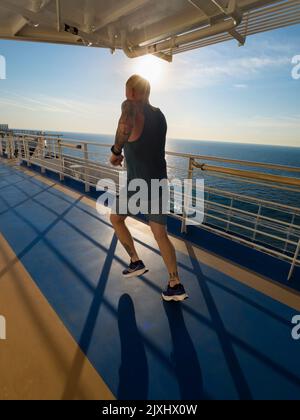 Running tracks are my secret weapon and favoured shooting venue when on board cruise liners. Not only do they help in the fight against lashings of ov Stock Photo