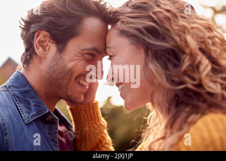 Portrait Of Happy Loving Couple Head To Head Outdoors Stock Photo