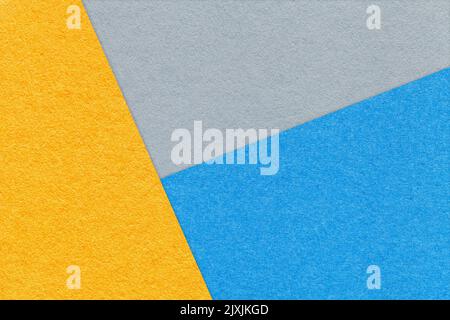 Texture of craft yellow, blue and gray shade color paper background, macro. Structure of vintage abstract cardboard with geometric shape and gradient. Stock Photo