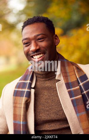 Head And Shoulders Portrait Of Man On Walk Through Autumn Countryside Against Golden Leaves Stock Photo