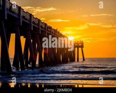 Sunrise over the Atlantic Ocean and the Jacksonville Baech pier in Jacksonville Beach Florida USA Stock Photo