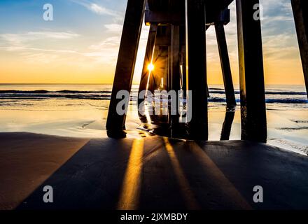 Sunrise over the Atlantic Ocean and the Jacksonville Baech pier in Jacksonville Beach Florida USA Stock Photo