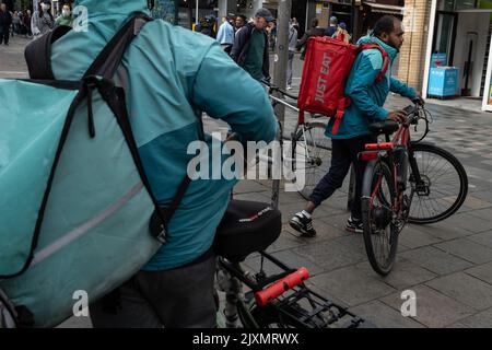 Fast food delivery bikers in the city streets, in Glasgow, Scotland, 7 September 2022. Stock Photo