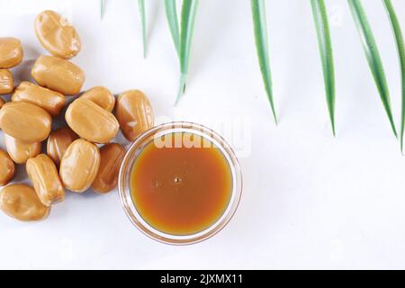 caramel chocolate bar and liquid on white background, top view  Stock Photo
