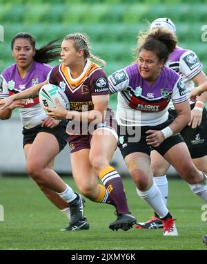 Julia Robinson of the Broncos (right) is tackled by Ruan Sims of the  Roosters during the NRL Women's Premiership match between the Sydney  Roosters and the Brisbane Broncos at Allianz Stadium in