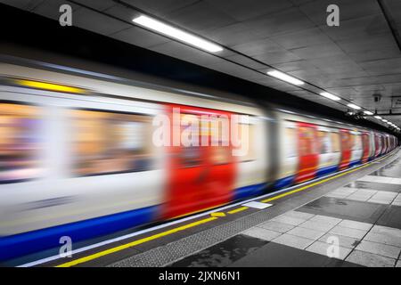Moving tube train in an undergroud metro station, London Stock Photo