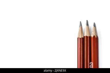 three sharpened pencils close up isolated on white background. tool for drawing, drafting and drawing up plan of action Stock Photo