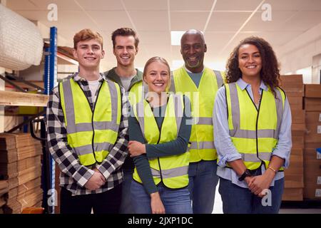 Portrait Of Multi-Cultural Team Wearing Hi-Vis Safety Clothing Working In Modern Warehouse Stock Photo