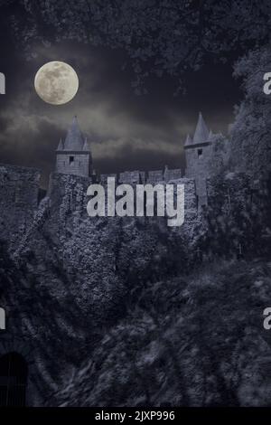 Old medieval castle in a cloudy full moon night Stock Photo