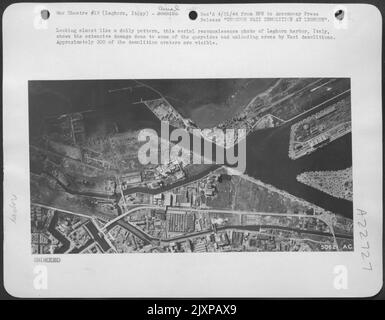 Looking almost like a doily pattern, this aerial reconnaissance photo of Leghorn harbor, Italy, shows the extensive damage done to some of the quaysides and unloading areas by Nazi demolitions. Approximately 200 of the demolition craters are visible. Stock Photo